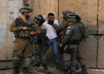 Israeli forces arrest a Palestinian man after the identity questioning in Hebron, West Bank on October 13, 2022 [Amer Shallodi/Anadolu Agency]