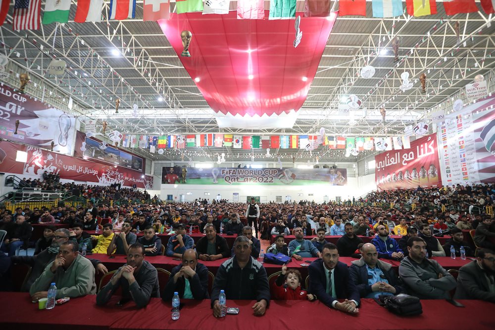 November 26, 2022, Palestinian fans gather at a public place to attend FIFA World Cup 2022 match between Poland and Saudi Arabia in Gaza City. Qatar Committee for the Reconstruction of Gaza has announced that the FIFA World Cup Qatar 2022 matches will be displayed in Saad Sail Hall in the center of Gaza City for free.