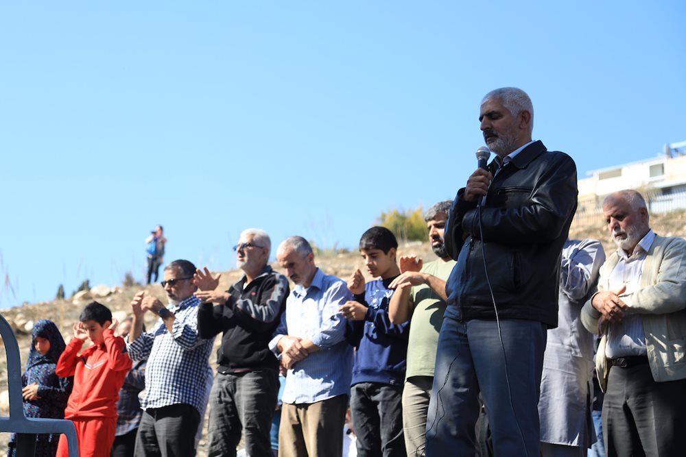 Palestinians perform Friday prayers in the Wadi Rababa neighborhood, to protest against Israeli settlement and fake graves, in Jerusalem on November 18, 2022. According to the head of the Committee for the Defense of Silwan, Fakhri Abu Diab, Israeli authorities placed over 50 fake graves north of the Jerusalem neighborhood of Silwan. 