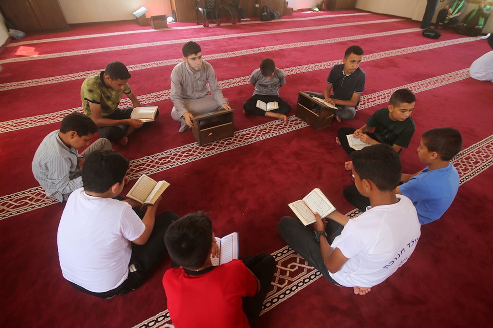 Palestinian children take part in a summer camp to memorize the Holy Quran in Khan Younis in the southern Gaza strip on July 8, 2023.
