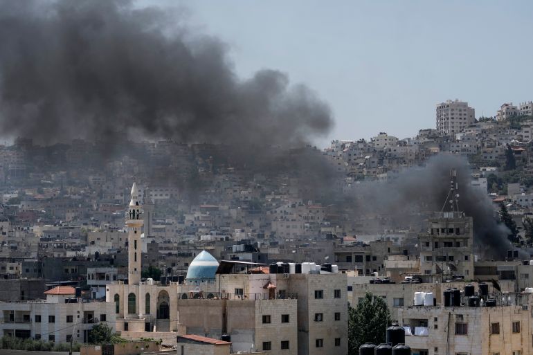Smoke rises during an Israeli military raid