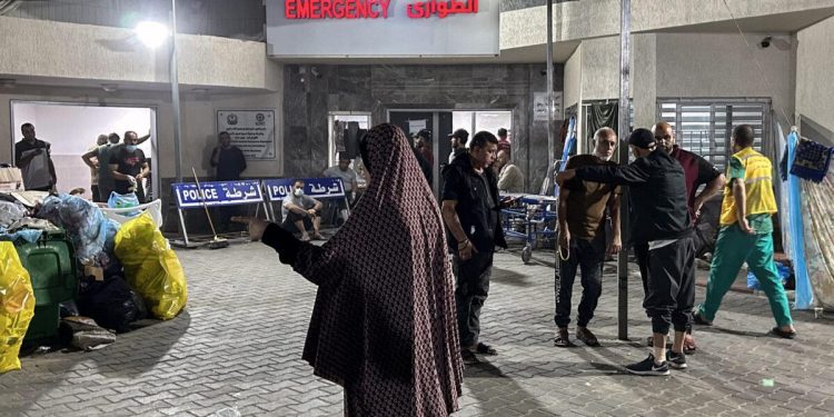 People stand outside the emergency ward of Al-Shifa hospital in Gaza City on November 10, 2023 [KHADER AL ZANOUN/AFP via Getty Images]