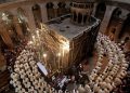 Roman Catholic clergymen circle the Edicule, which is believed to contain the tomb of Jesus (Credit: Gali Tibbon/AFP/Getty Images)