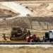 Pemandangan truk pengangkut buldozer militer Israel di dekat pagar perbatasan Israel-Gaza, terlihat dari Israel, 20 April 2025 (Amir Cohen/ Reuters)