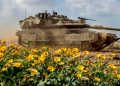 Tank Israel melewati jalan dengan bunga-bunga liar di dekat perbatasan Gaza (The Guardian)
